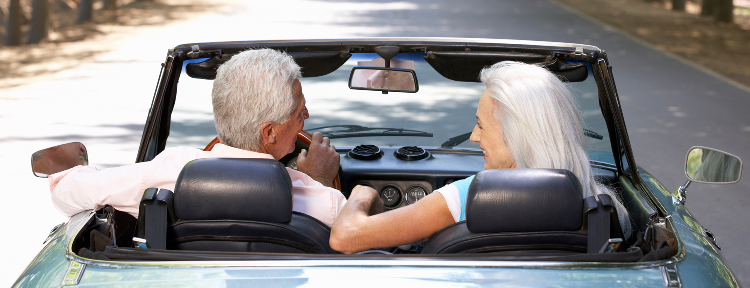 elderly couple with convertible car